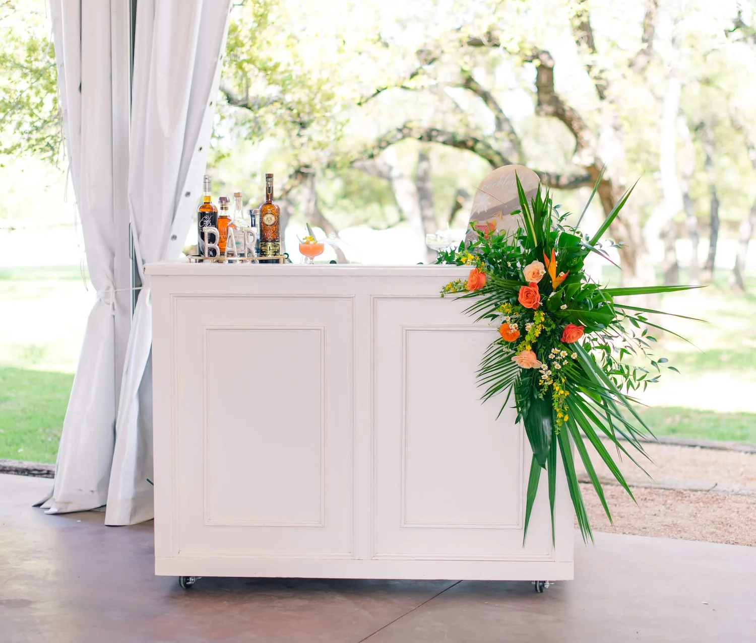 A styled bar cart with flowers