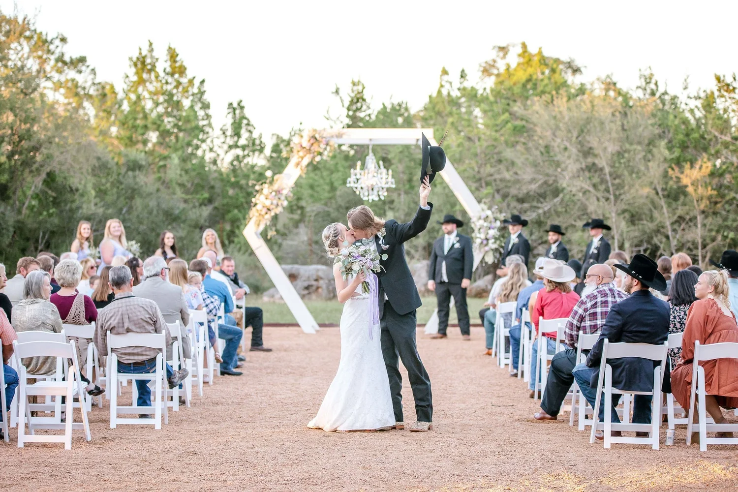 Outdoor ceremony with a hexagonal floral arch